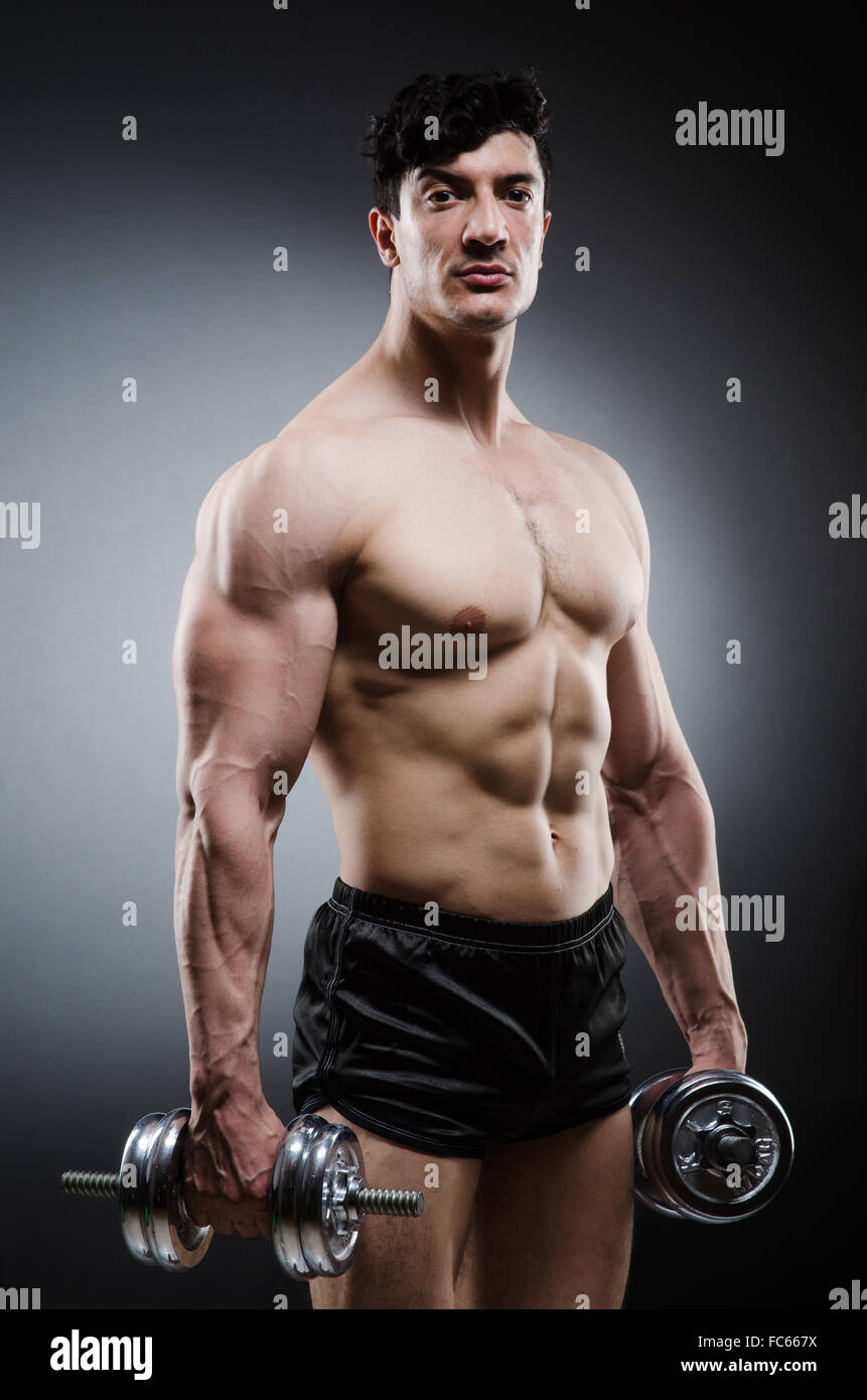 Muscular ripped bodybuilder with dumbbells Stock Photo - Alamy