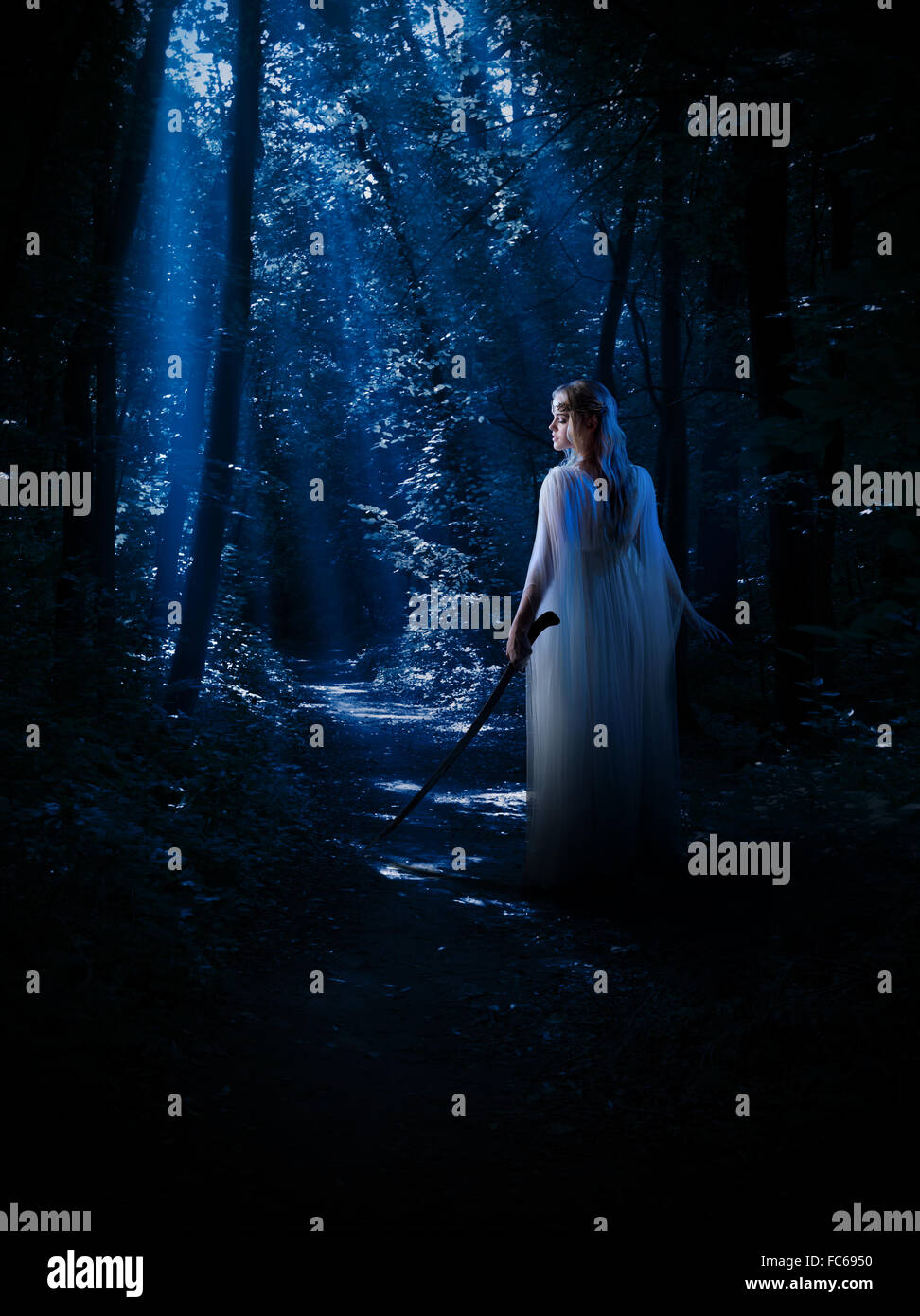 Young elven girl at night forest Stock Photo