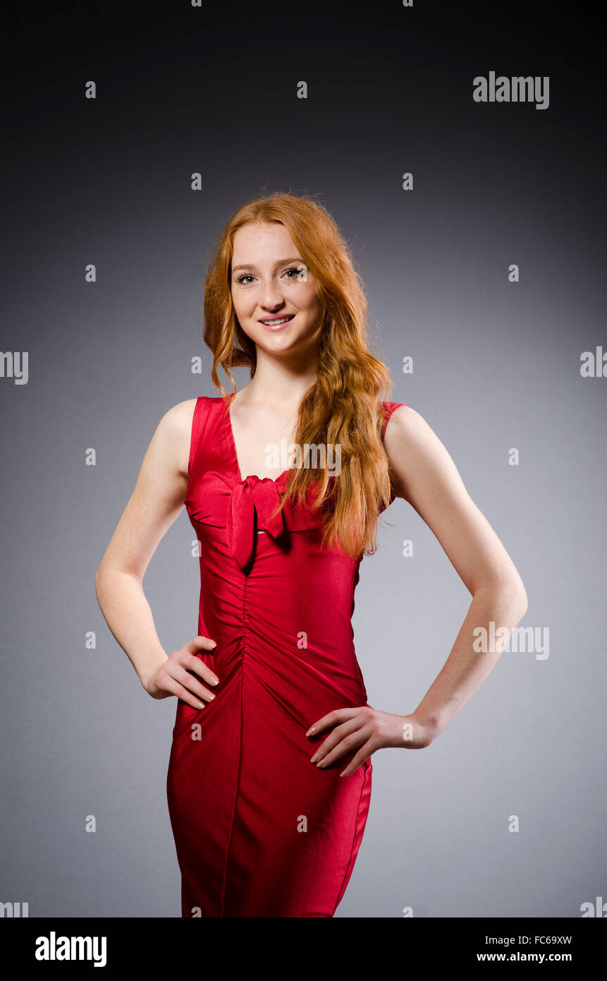 Girl in red dress against gray Stock Photo - Alamy