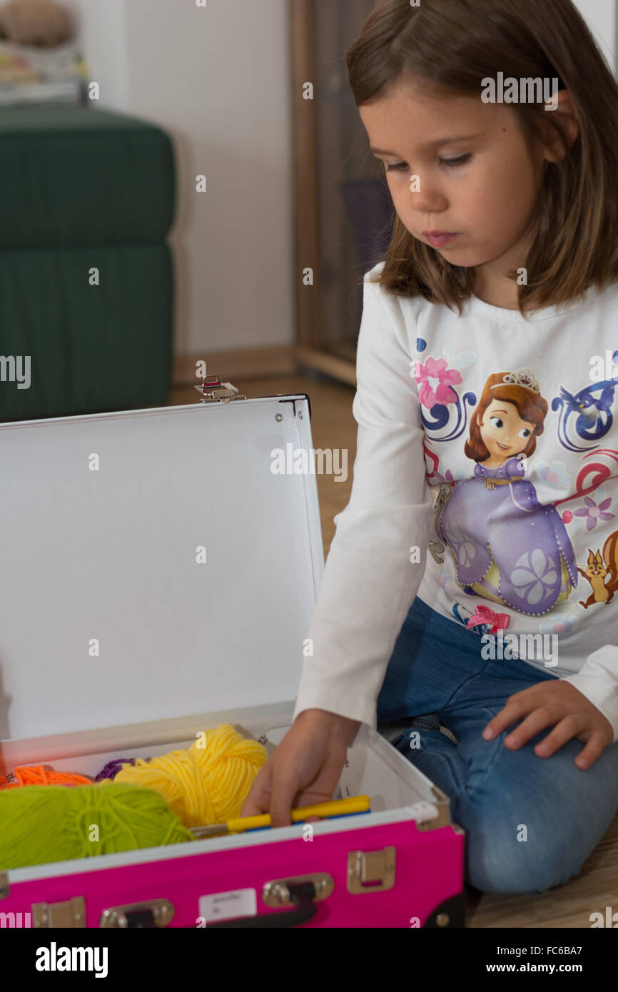 Schoolchild packed suitcases for needlework Stock Photo