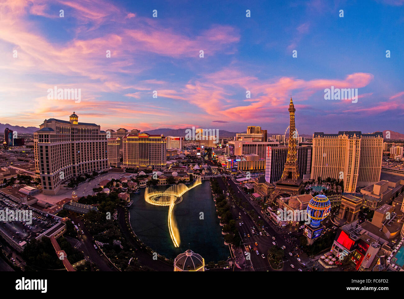 Fisheye view of the Bellagio Hotel fountain, Las Vegas skyline, Paris Hotel and the Las Vegas Strip at sunset. Stock Photo