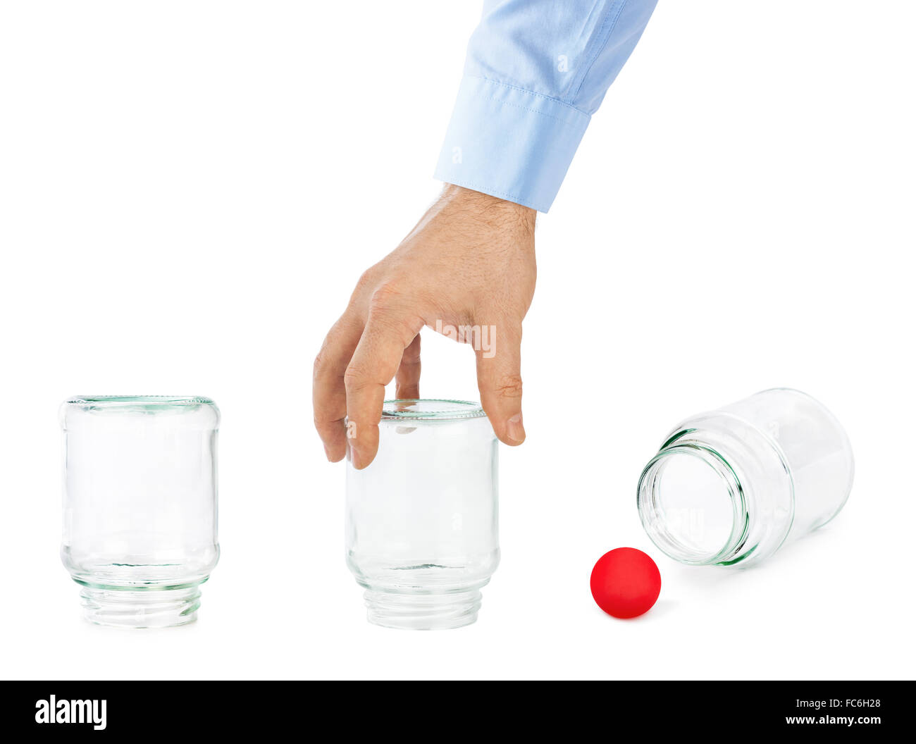 Hand and shell game with glass cans Stock Photo