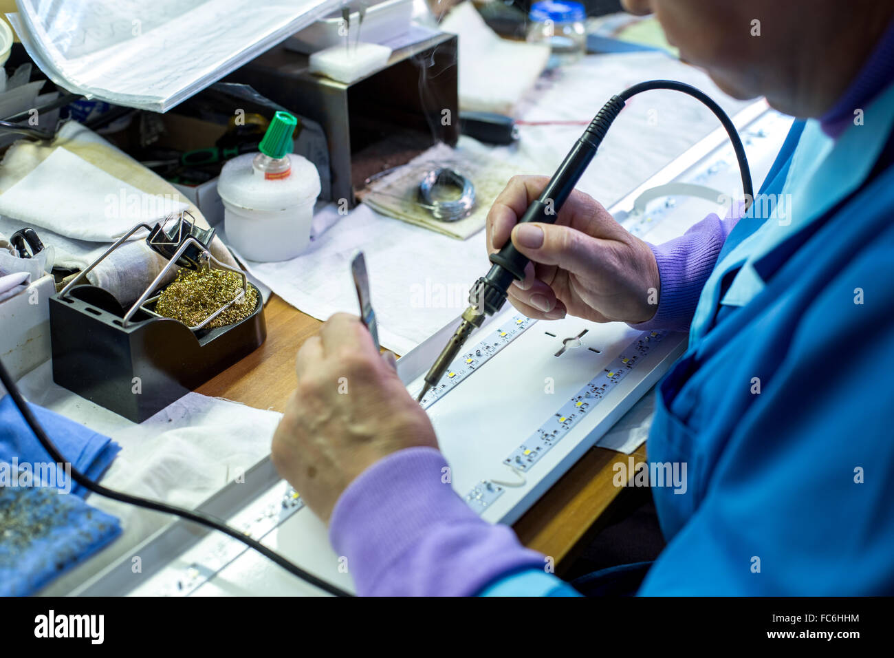 Manufacturing. Worker soldering circuit board Stock Photo Alamy
