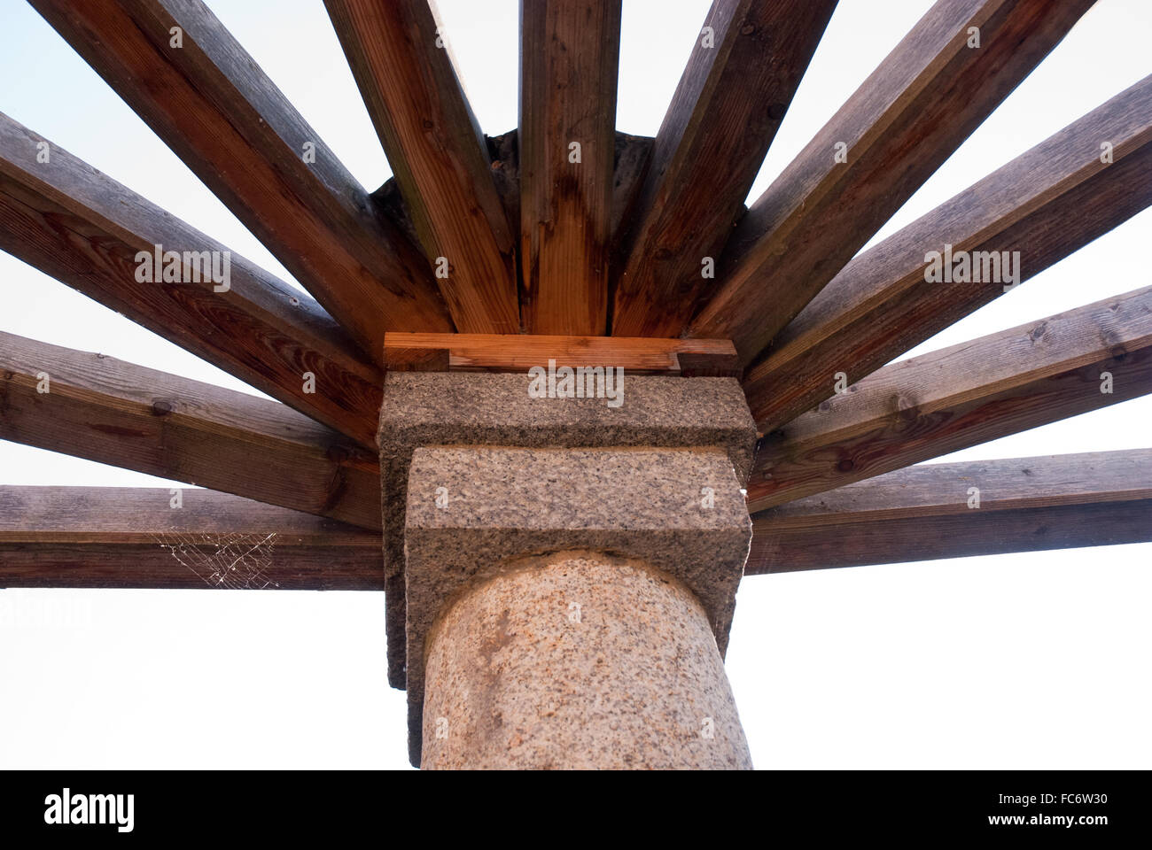column with wooden beams atop Stock Photo
