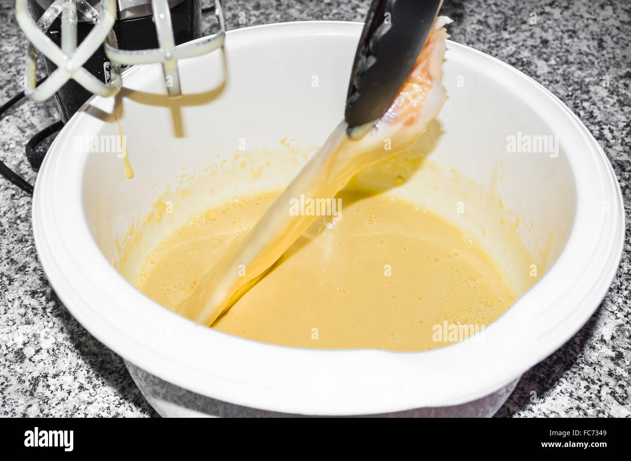 Fresh coley fillet is laid in beer batter. Stock Photo