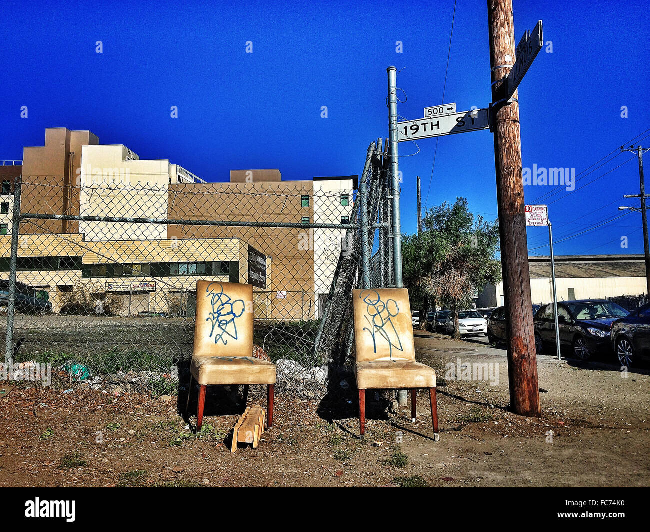 Dilapidated chairs on city sidewalk - Smartphone Captured Stock Image