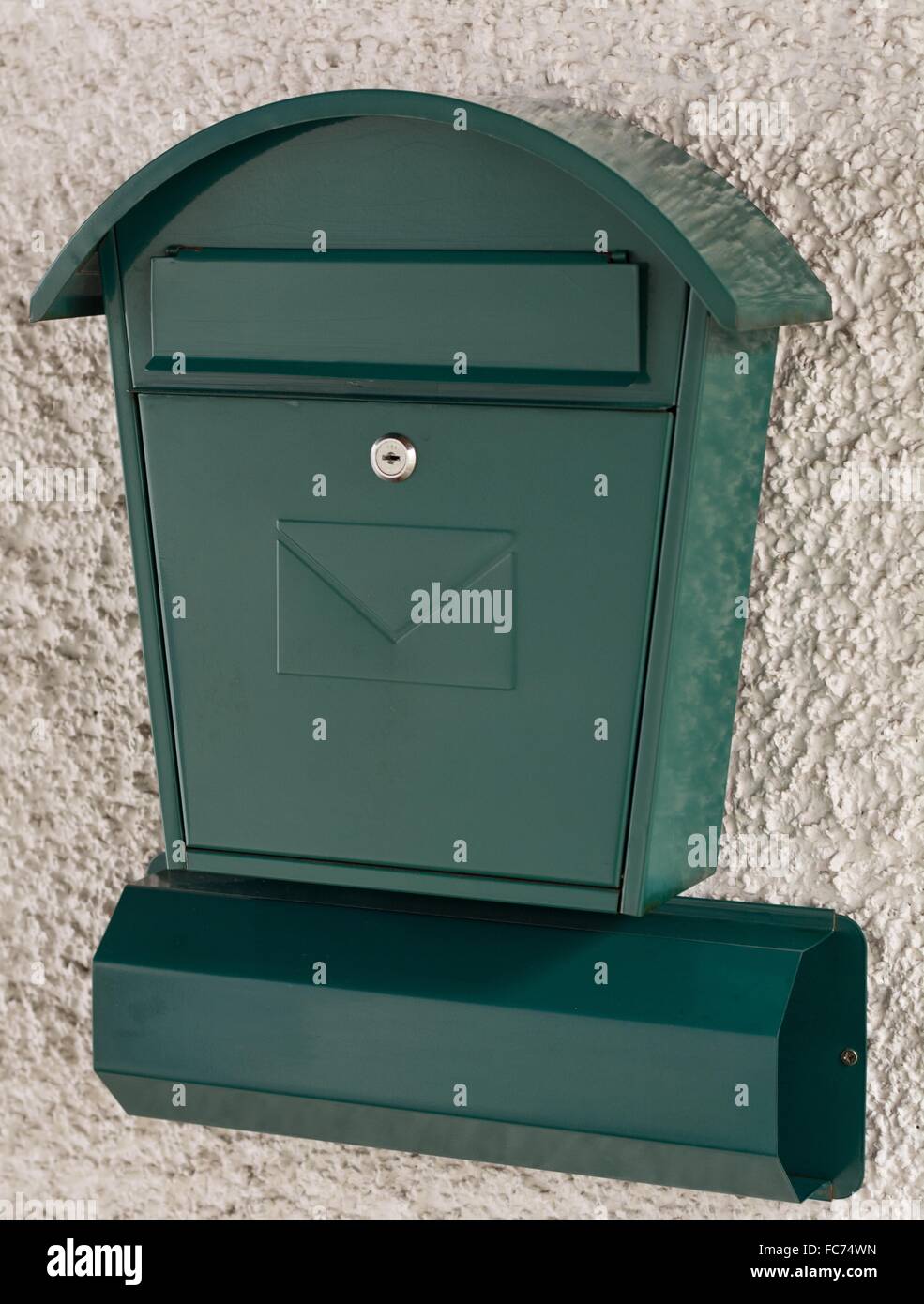 green postbox and newspaper holder Stock Photo