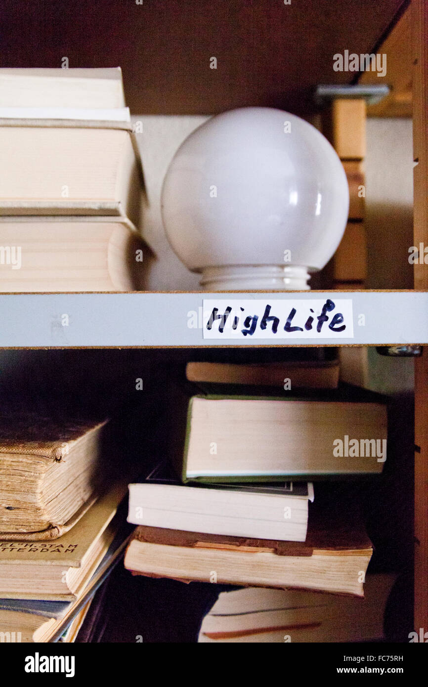 Close up of light bulb on shelf with books Stock Photo Alamy