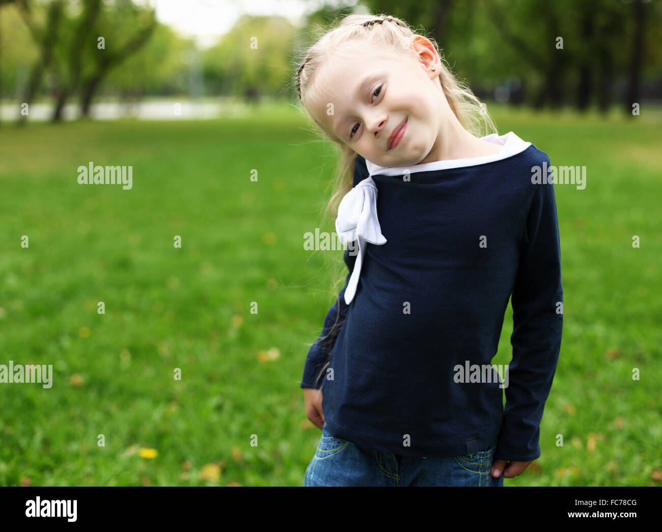 little happy girl in green summer park Stock Photo - Alamy