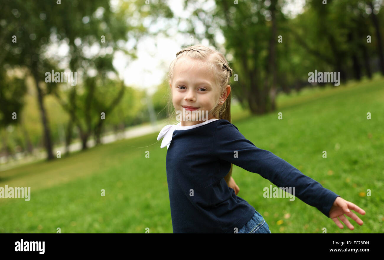 little happy girl in green summer park Stock Photo - Alamy