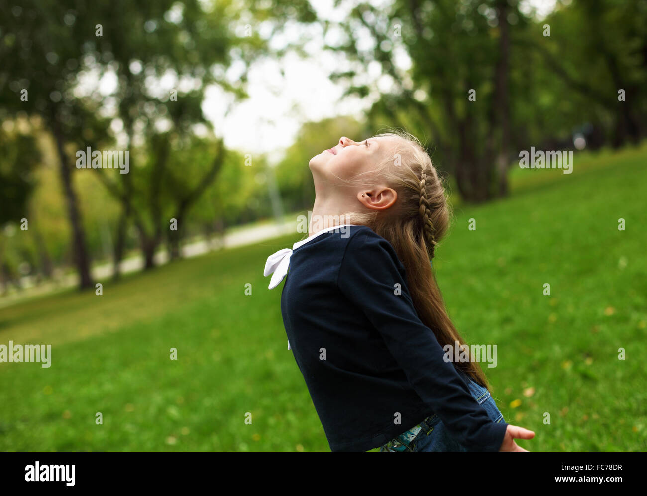 little happy girl in green summer park Stock Photo - Alamy