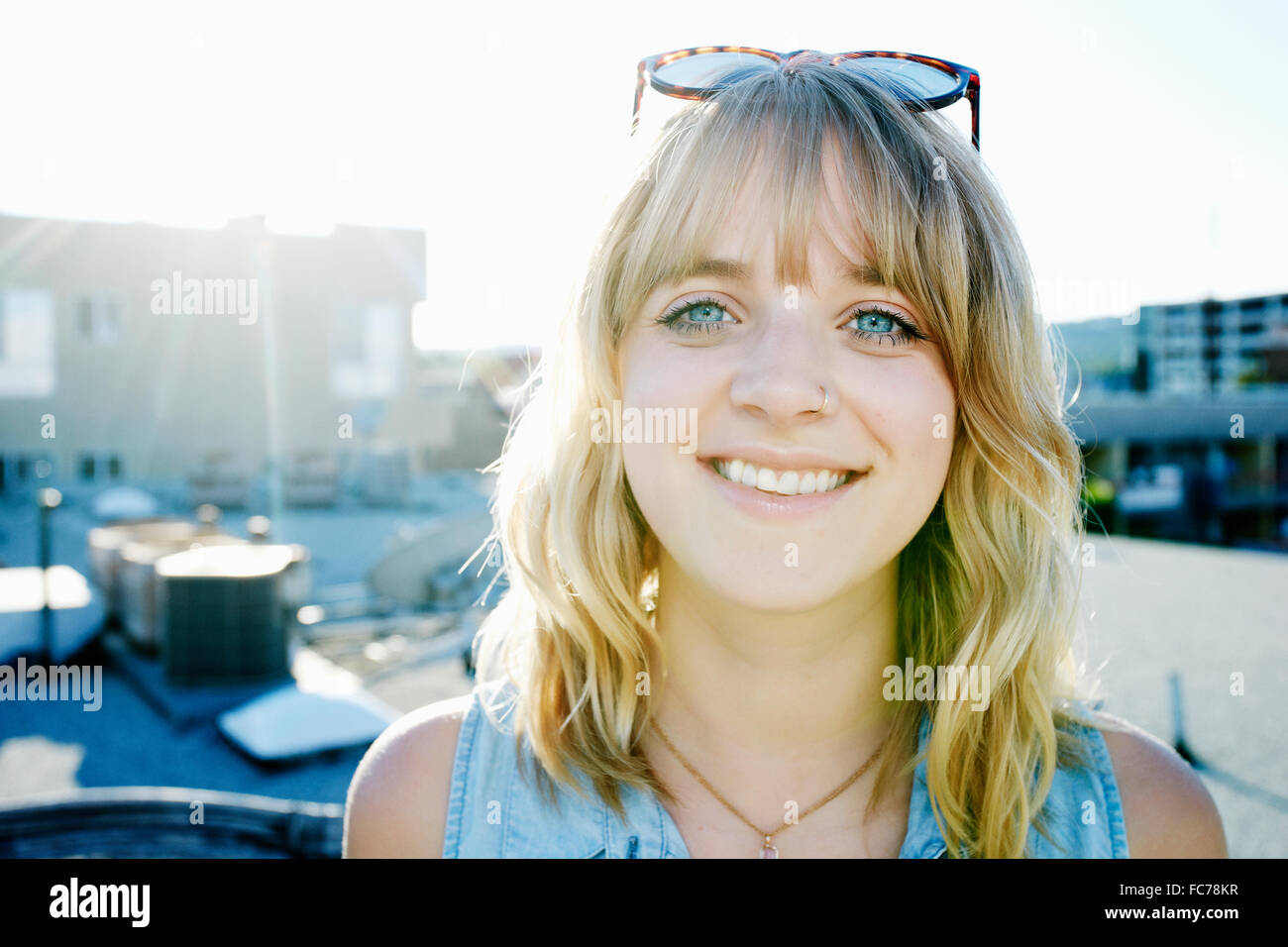 Caucasian woman smiling on urban rooftop Stock Photo