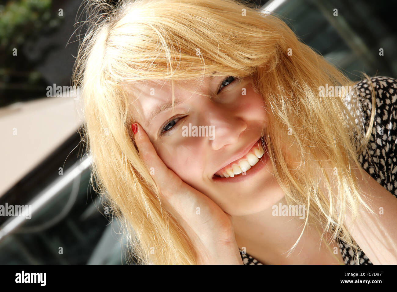 Smiling young woman in the sunlight Stock Photo - Alamy