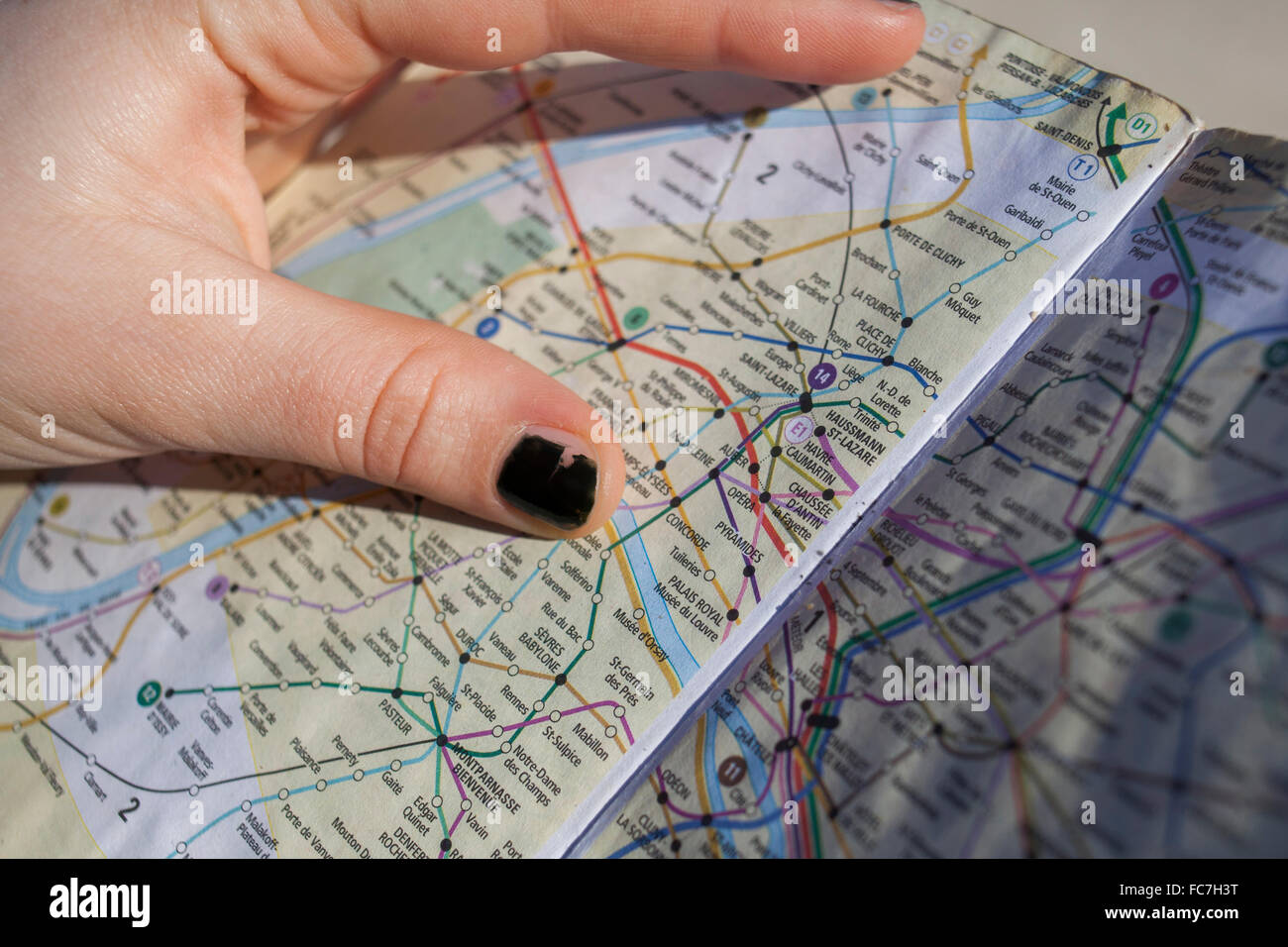 Close up of hand holding Paris city map, Paris, Ile-de-France, France Stock Photo