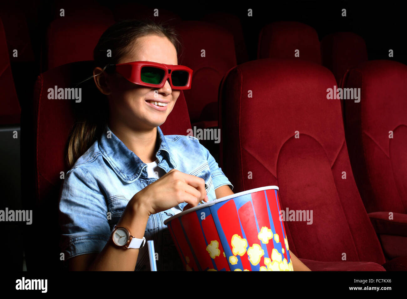 One young girl watching movie in cinema Stock Photo Alamy