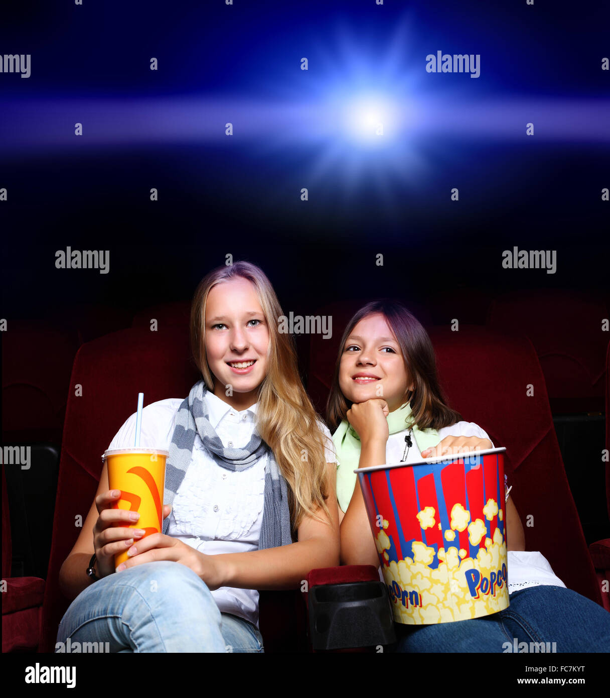 Two young girls watching movie in cinema Stock Photo Alamy