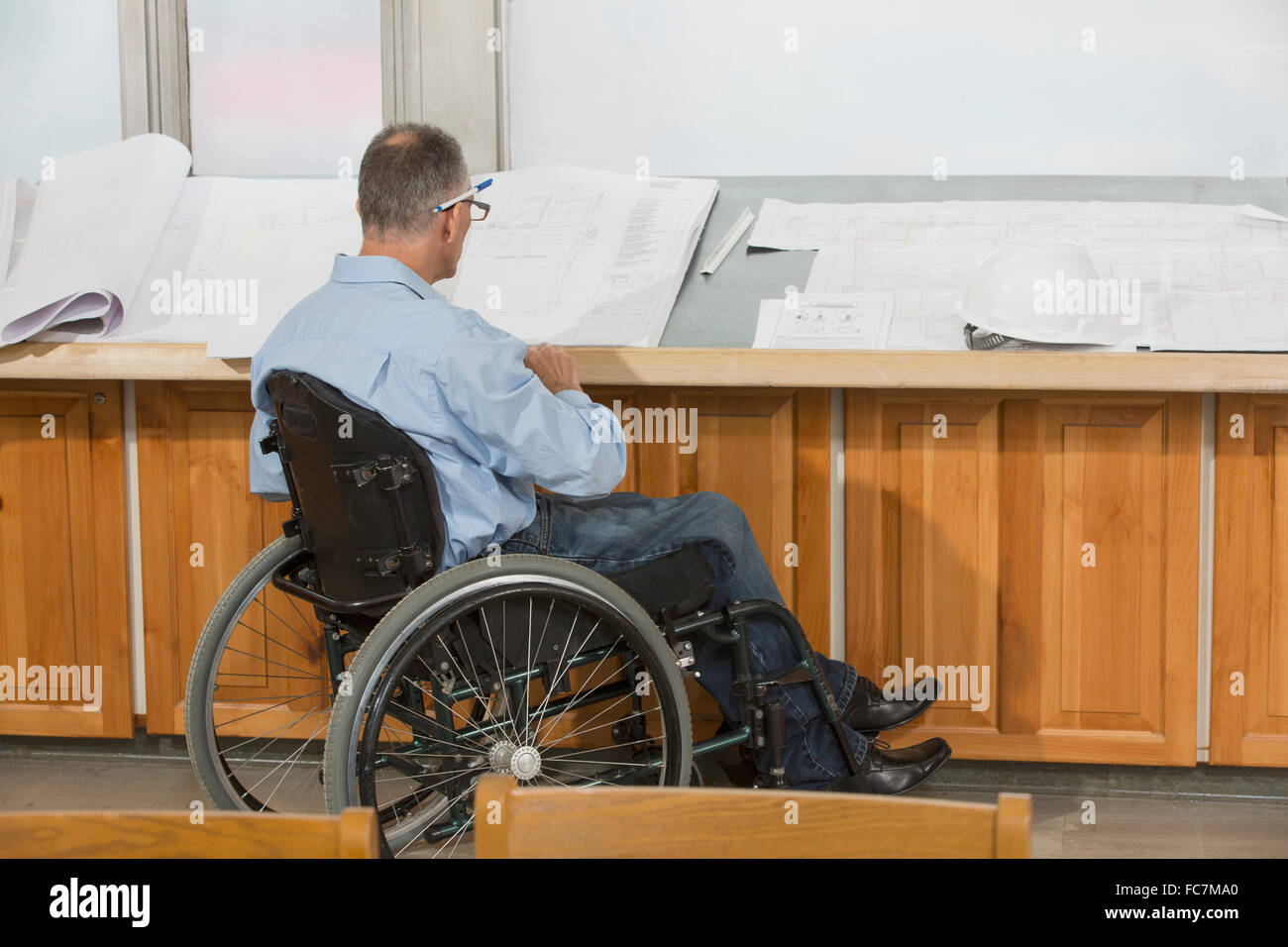 Caucasian architect in wheelchair talking in office Stock Photo Alamy