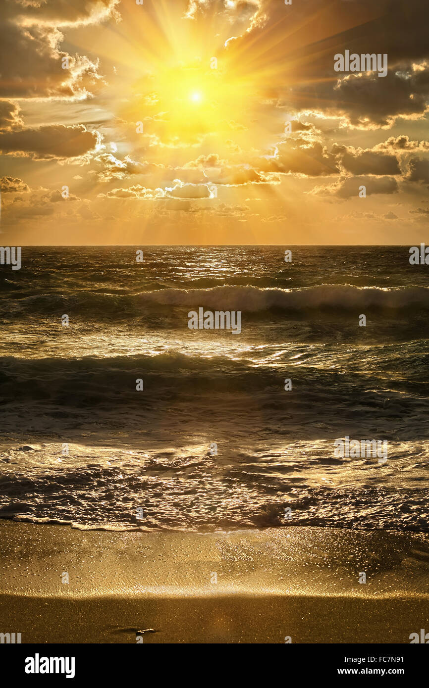 Golden sunset on the sea shore Stock Photo - Alamy