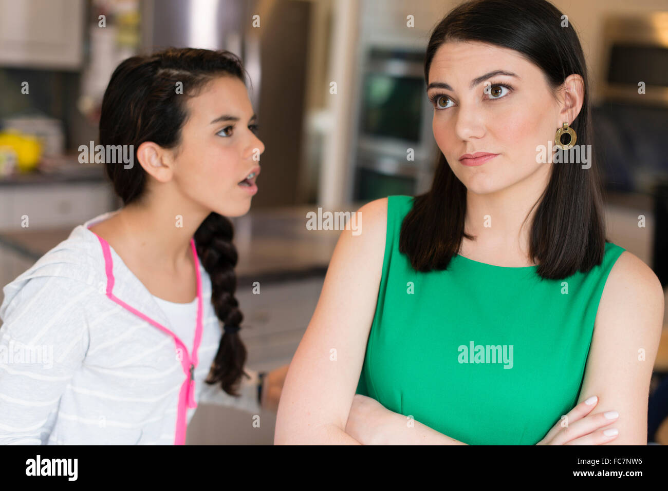 Mother and daughter arguing in kitchen Stock Photo