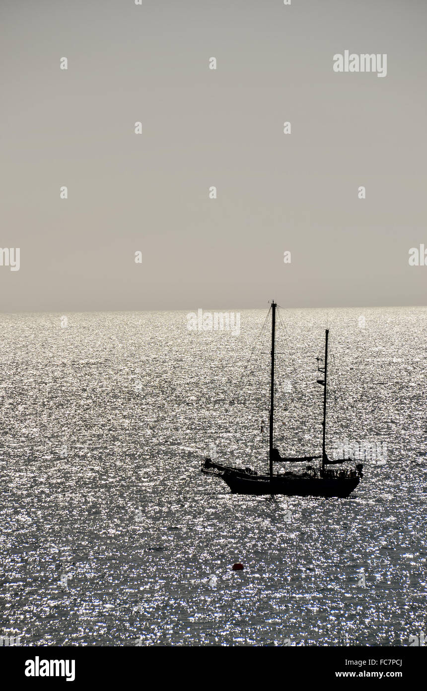 Silhouette Boat in the Ocean Stock Photo - Alamy