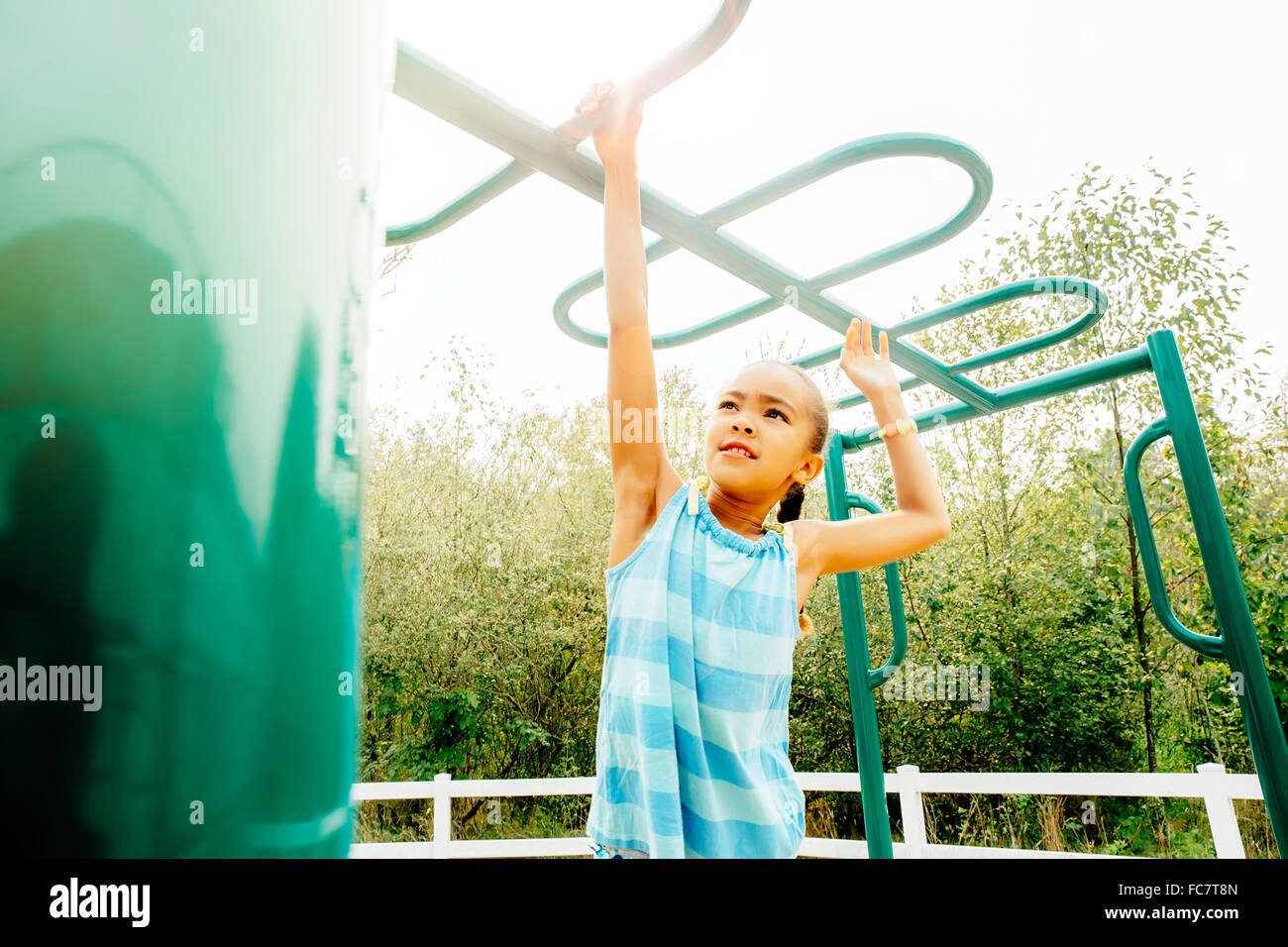 Mixed race girl playing on playground Stock Photo