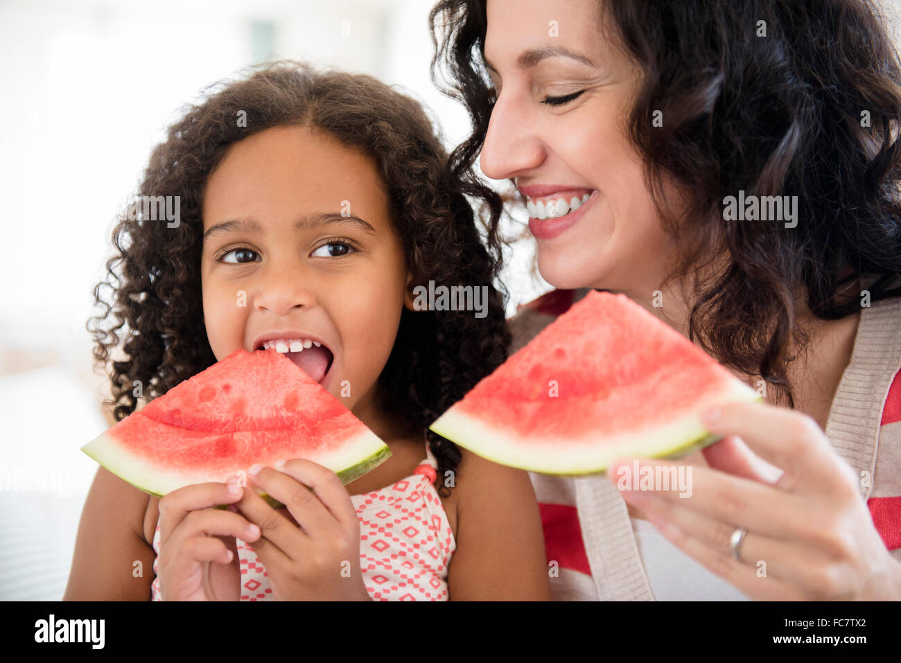 Mother and daughter eating watermelon Stock Photo