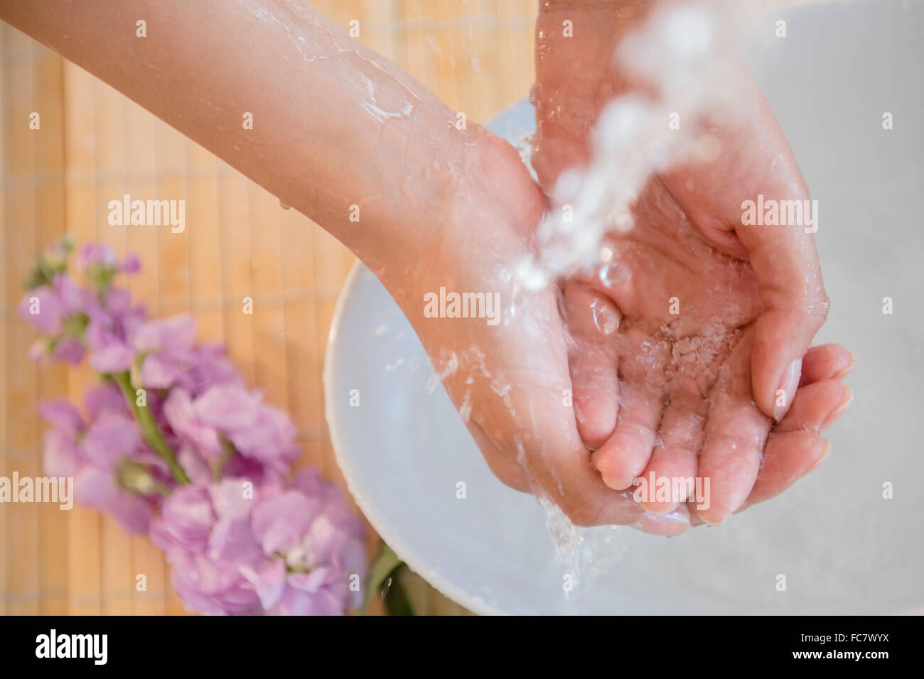 Hispanic woman washing hands Stock Photo