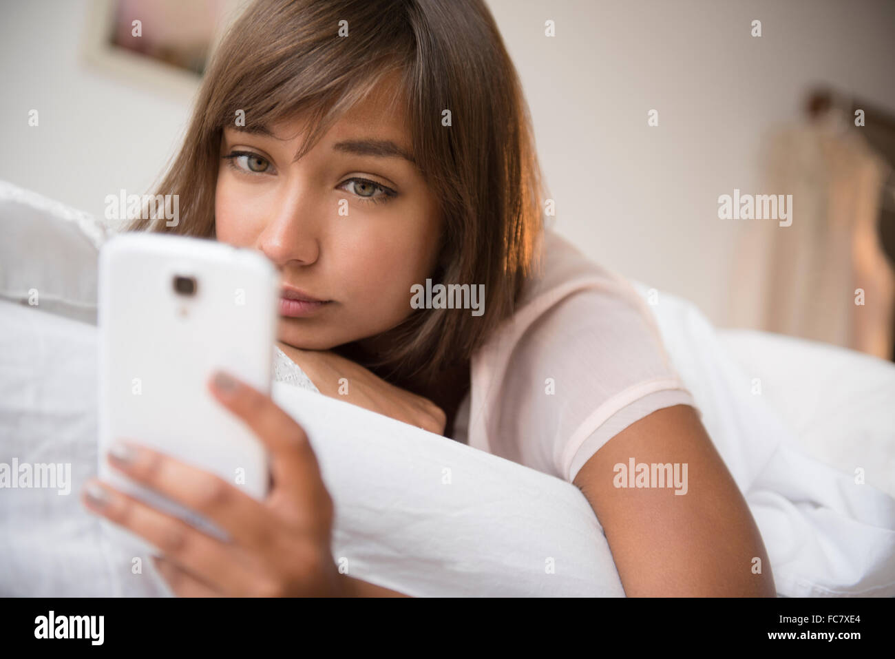 Mixed race woman using cell phone Stock Photo