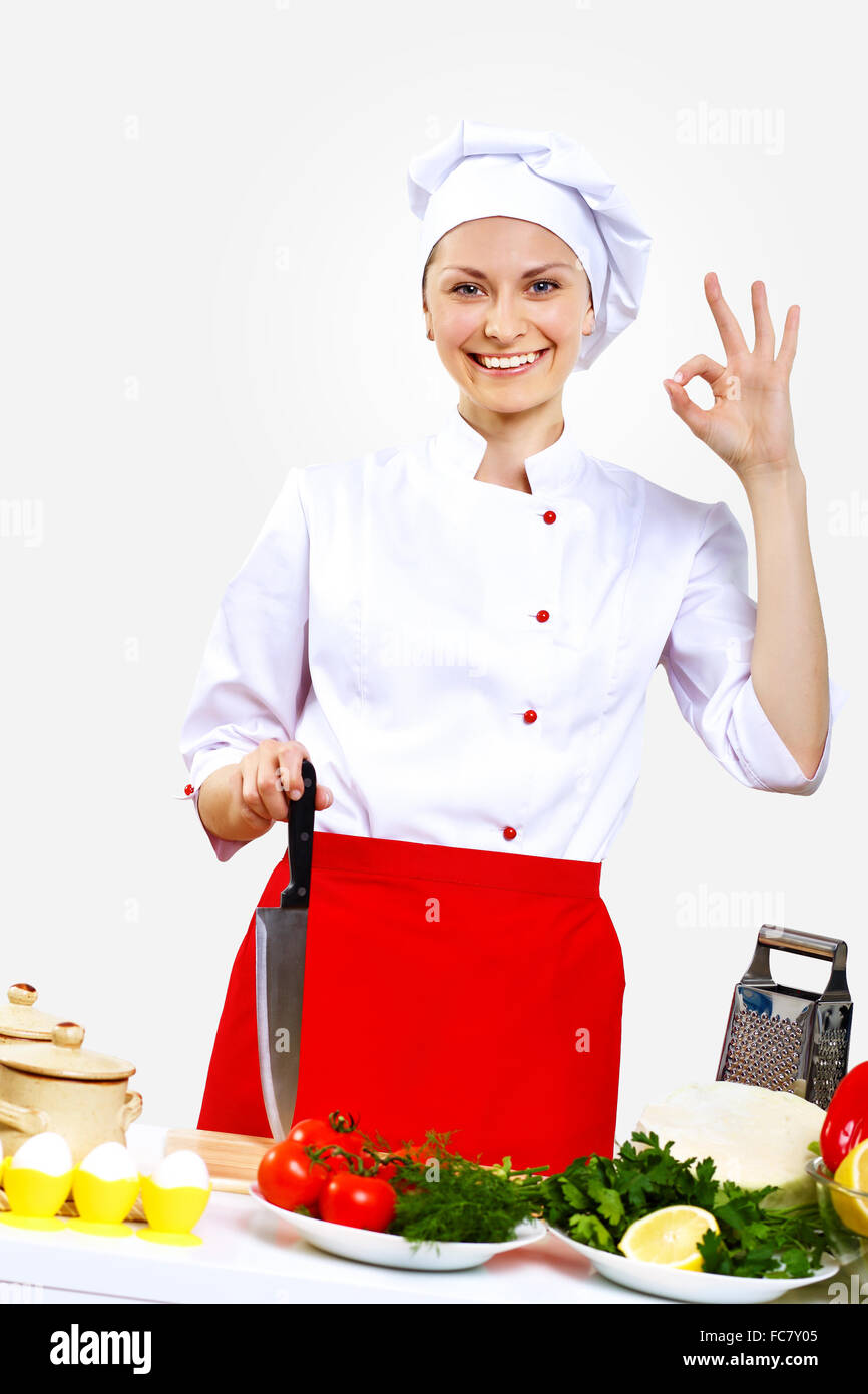 Portrait of a young cook in uniform preparing meal Stock Photo - Alamy