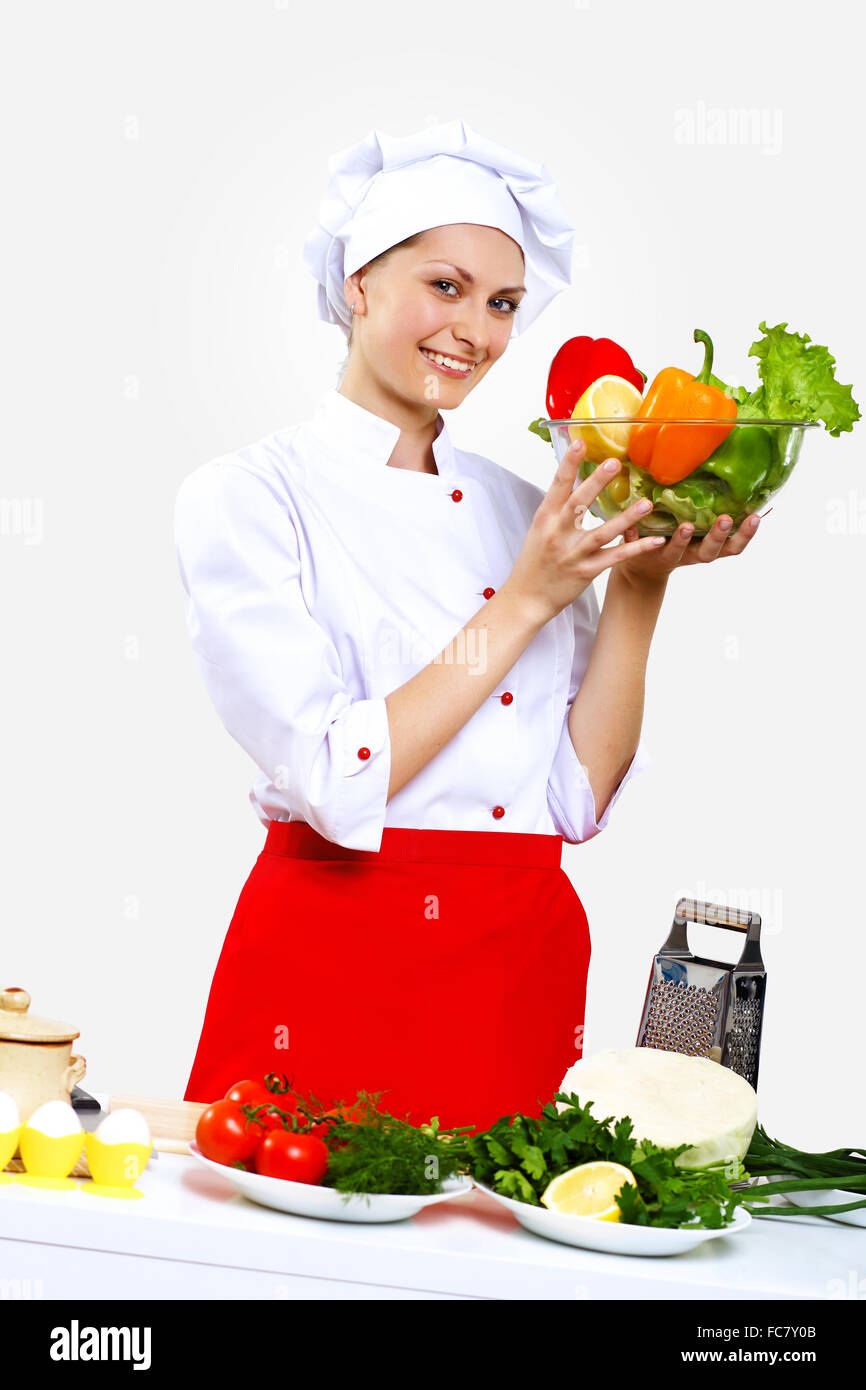 Portrait of a young cook in uniform preparing meal Stock Photo - Alamy