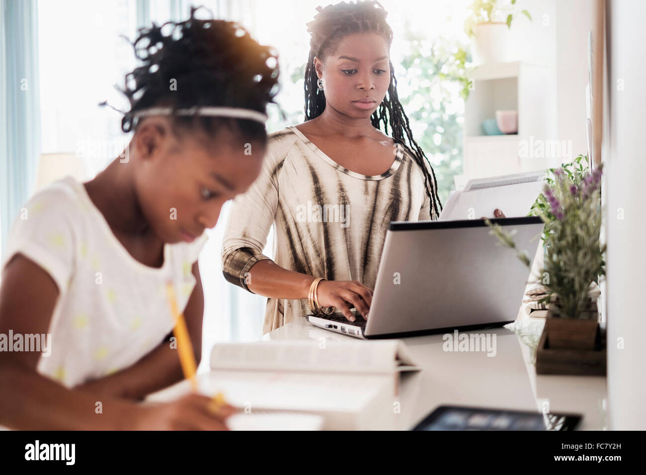 Black mother and daughter studying Stock Photo