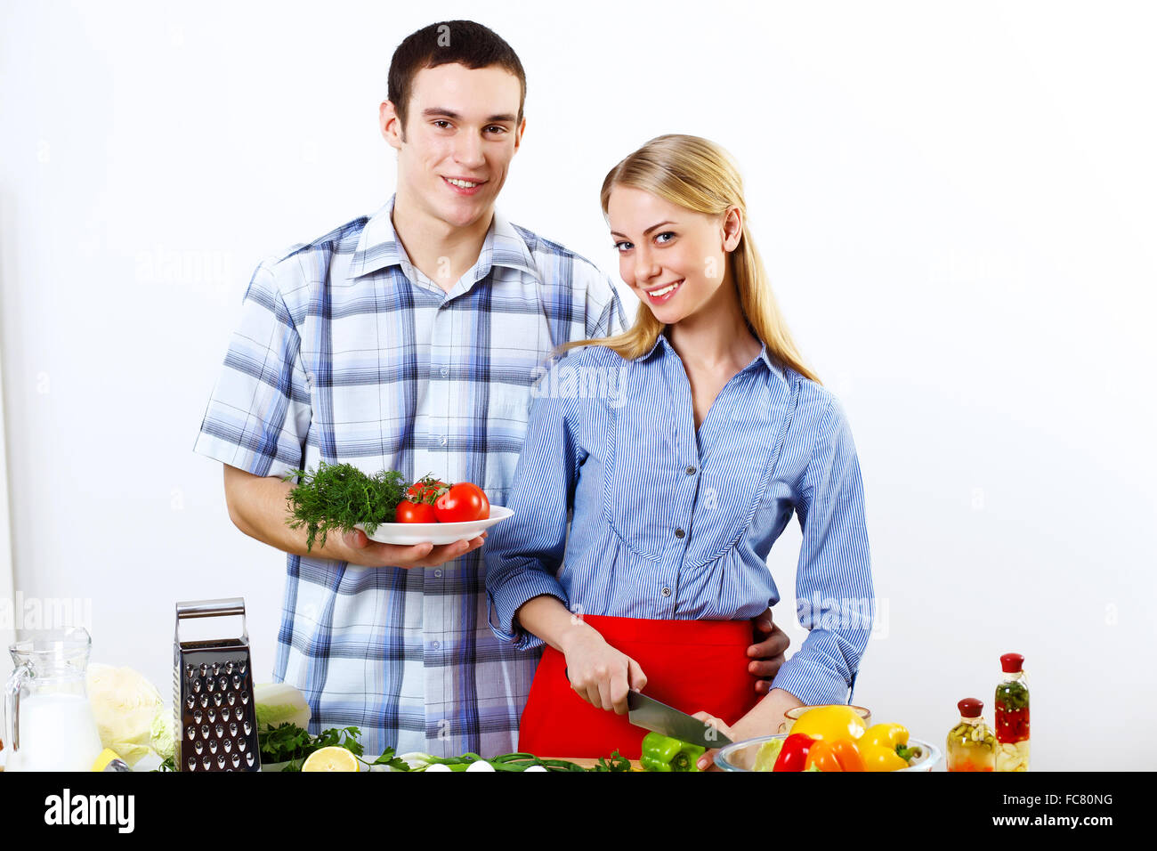 Young husband and wife together coooking at home Stock Photo Alamy