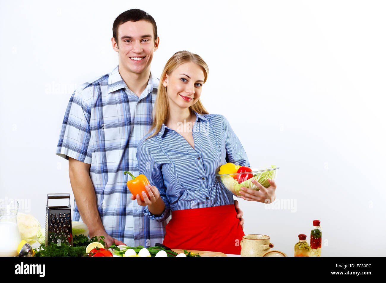 Young husband and wife together coooking at home Stock Photo Alamy