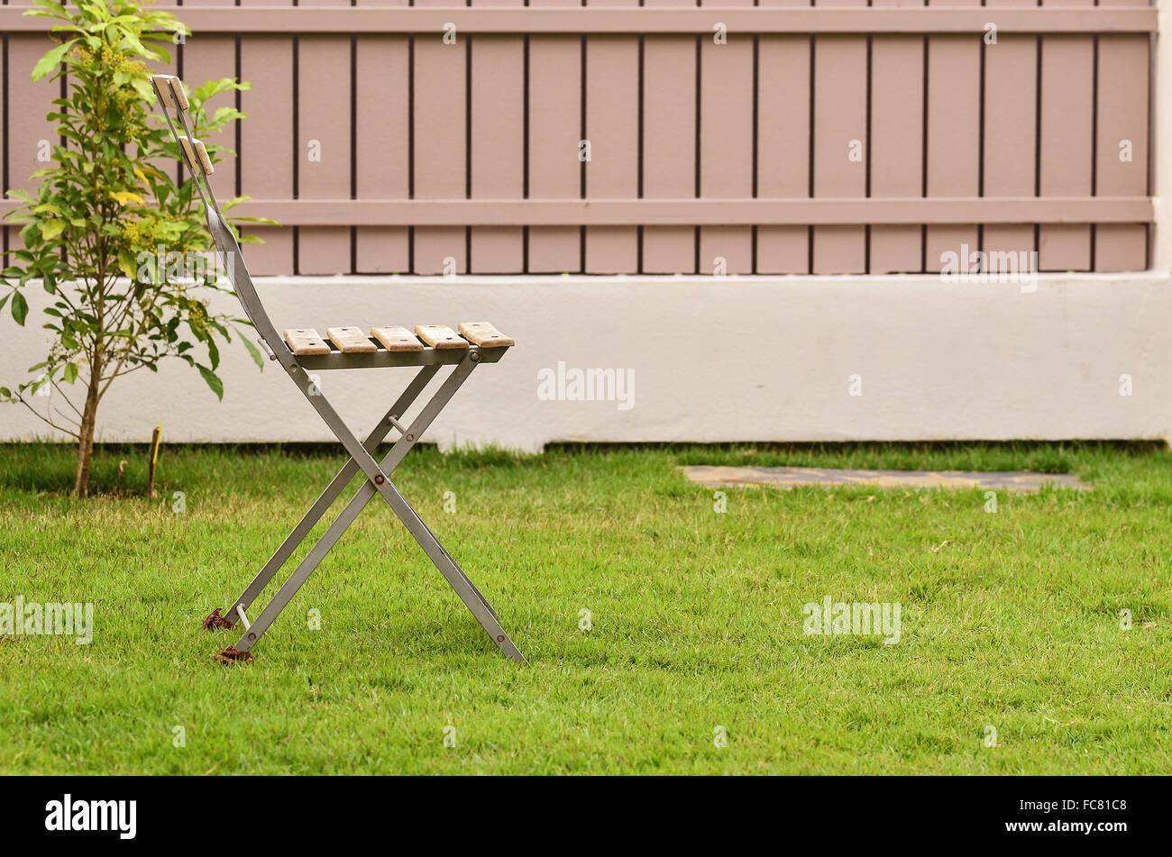 Old chair on green grass Stock Photo