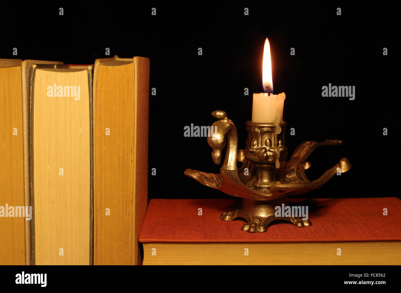 old books with candle Stock Photo Alamy
