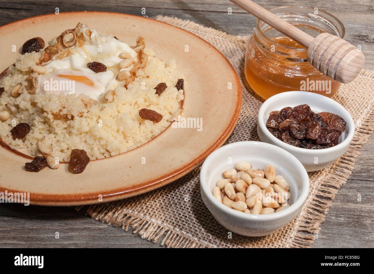 Cous cous with fried egg and honey Stock Photo