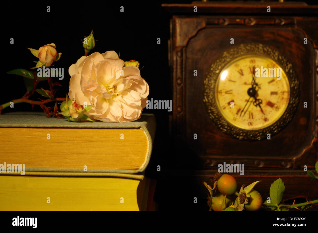 still life with old books, rose and clock Stock Photo - Alamy