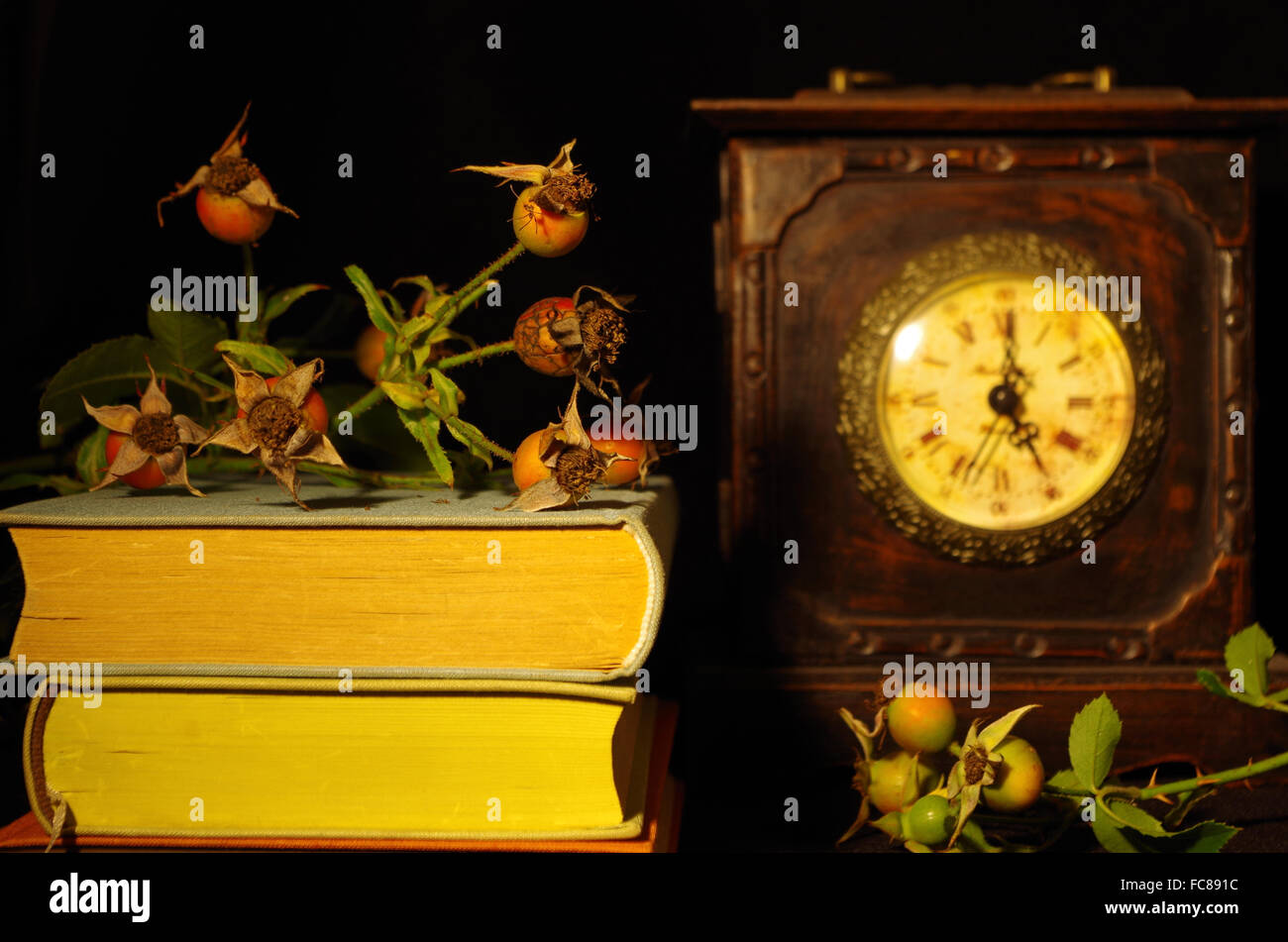 still life with old books, rose and clock Stock Photo - Alamy