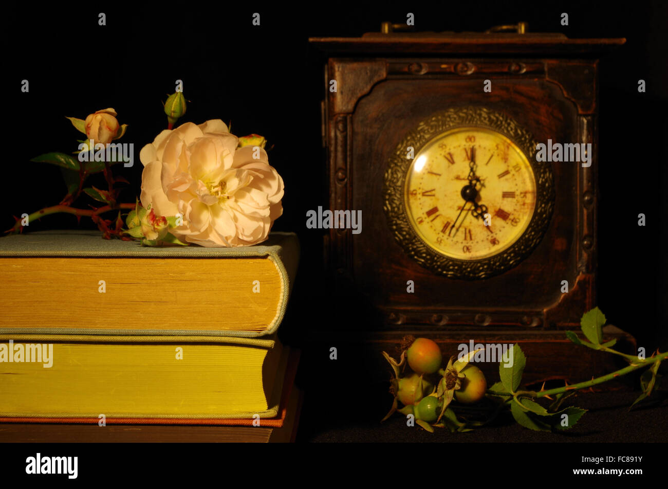 still life with old books, rose and clock Stock Photo - Alamy
