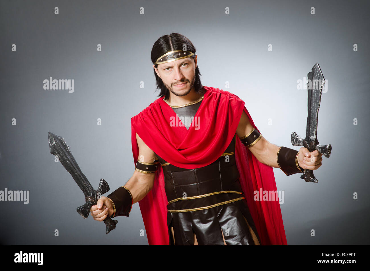 Roman warrior with sword against background Stock Photo - Alamy