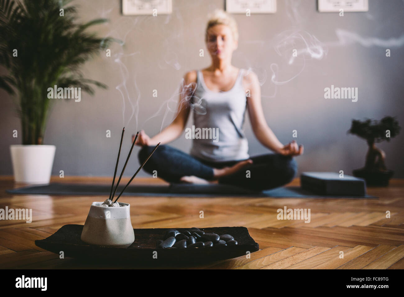 Caucasian woman meditating in yoga studio Stock Photo - Alamy