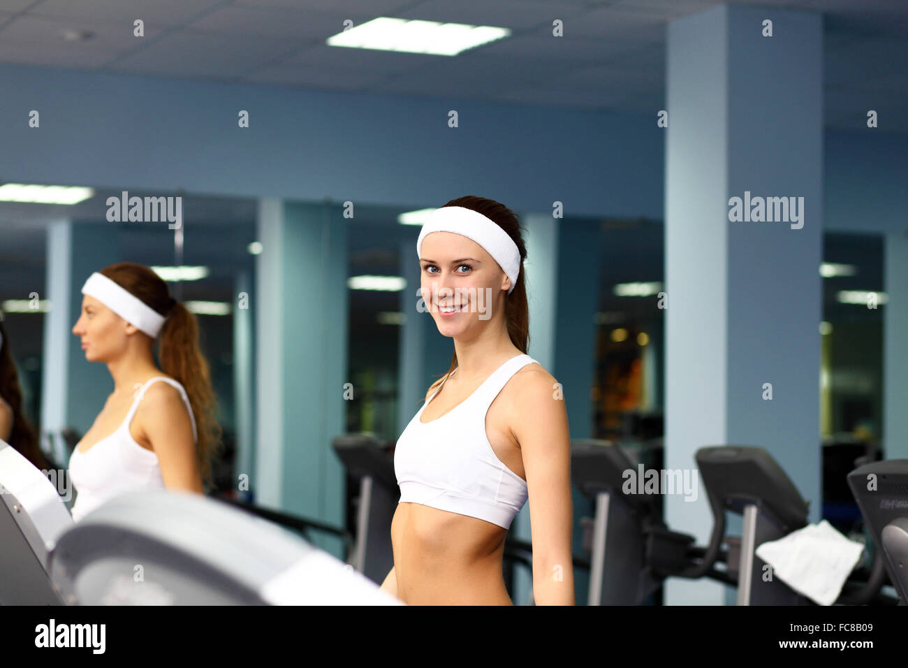 Young woman in sport wear doing sport in gym Stock Photo - Alamy