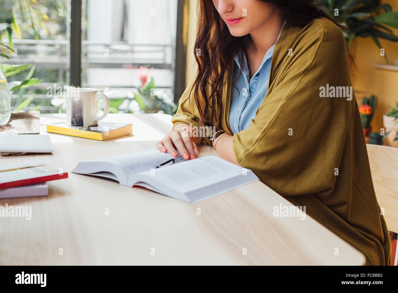 Caucasian woman studying at desk Stock Photo