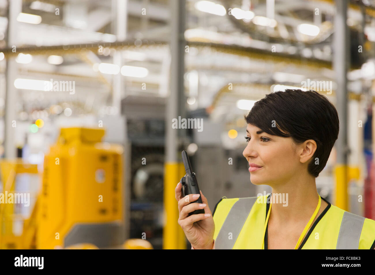 Worker using walkie-talkie in factory Stock Photo