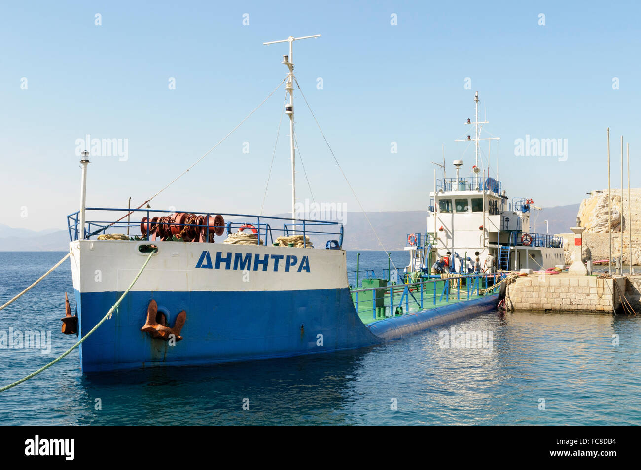 Greece, Saronic Islands, Hydra. A moored tanker offloads its cargo of freshwater to the island. Stock Photo