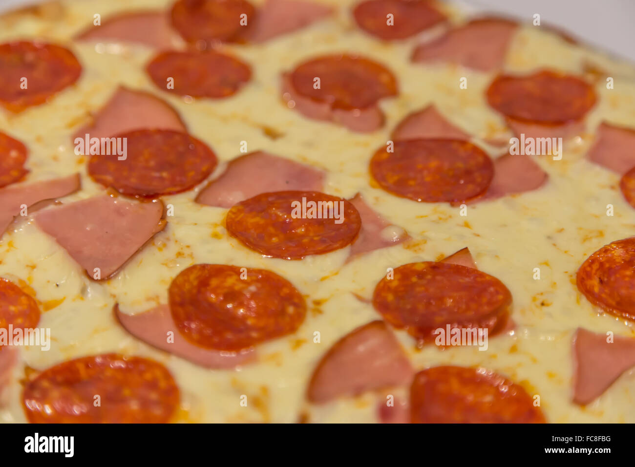 Thinly sliced pepperoni and jam popular pizza topping in Americanstyle pizzerias Stock Photo