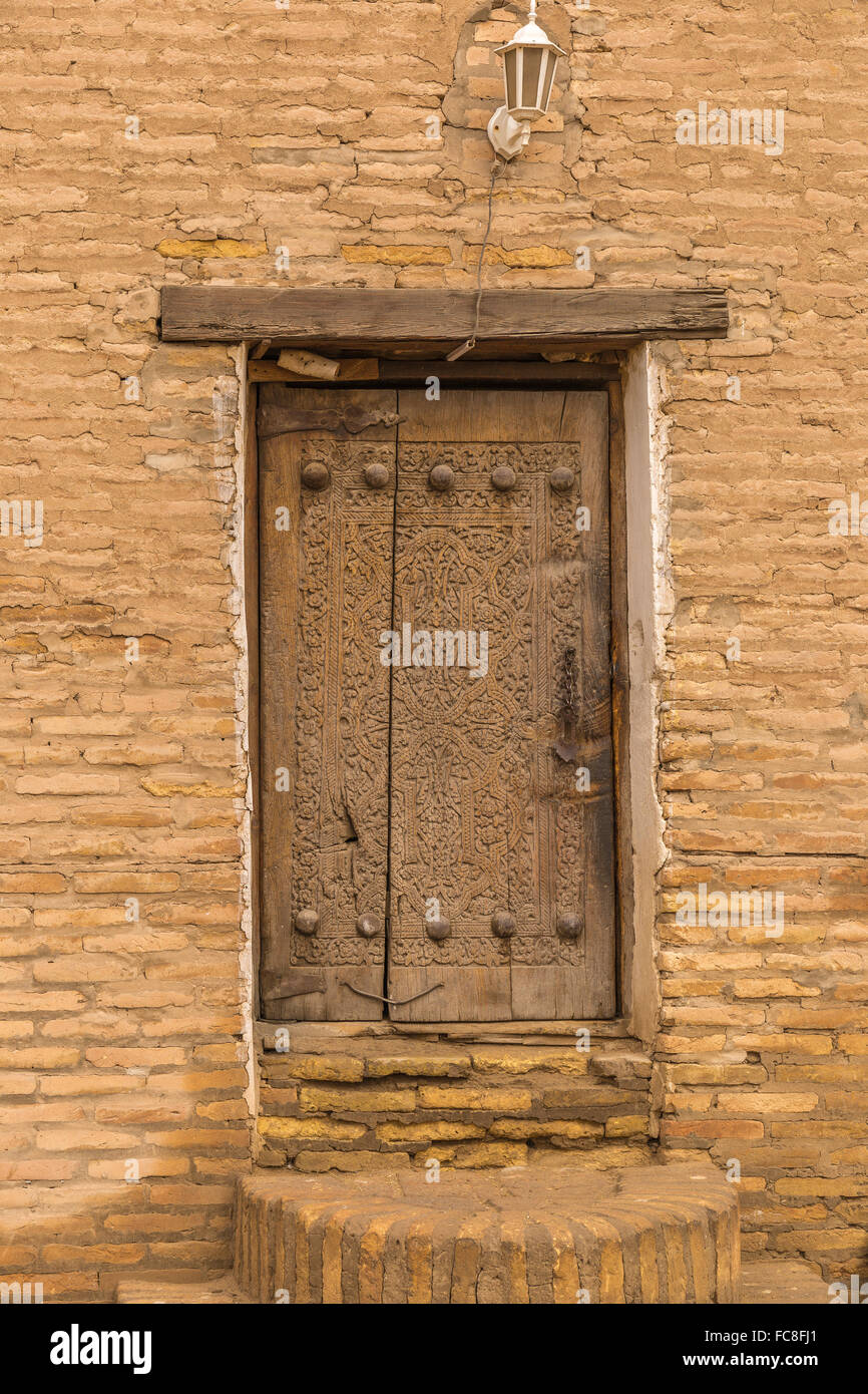 Intricately carved wooden door within Incha-Kala Stock Photo - Alamy