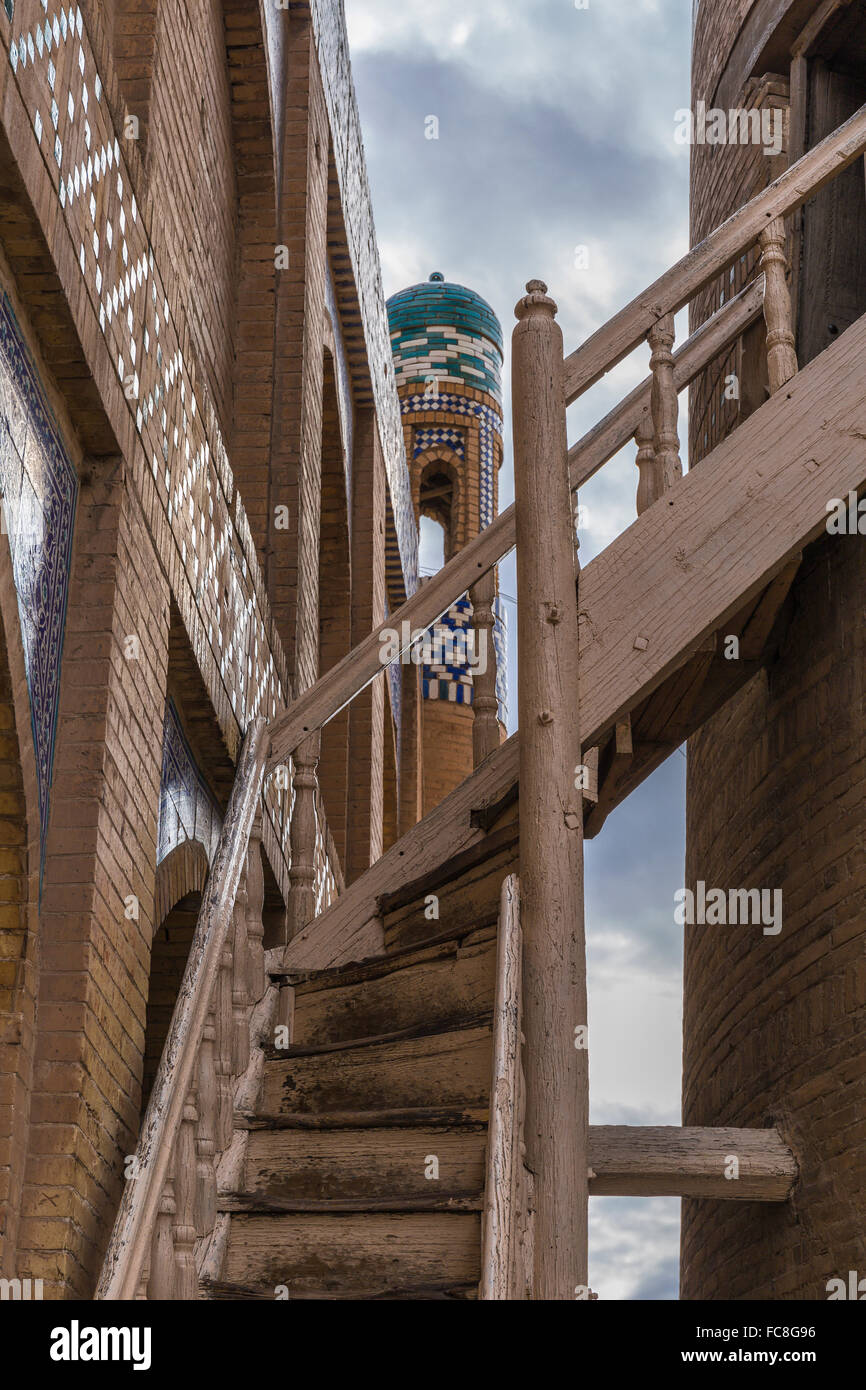 Wooden (and treacherous) staircase leading to the highest minaret in Ichan-Kala. Stock Photo