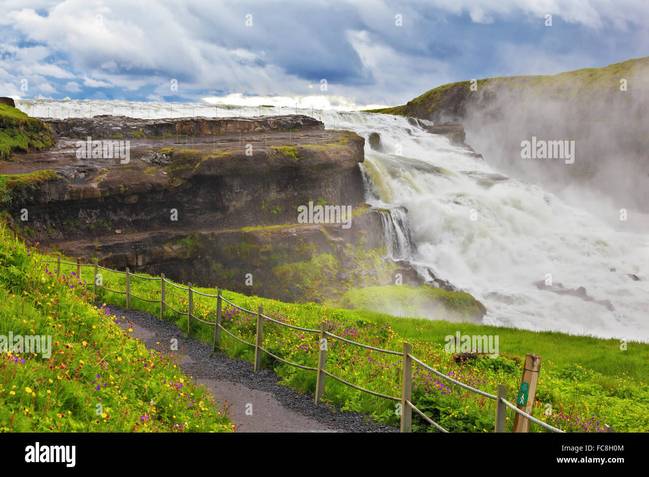 Powerful waterfall and convenient path Stock Photo