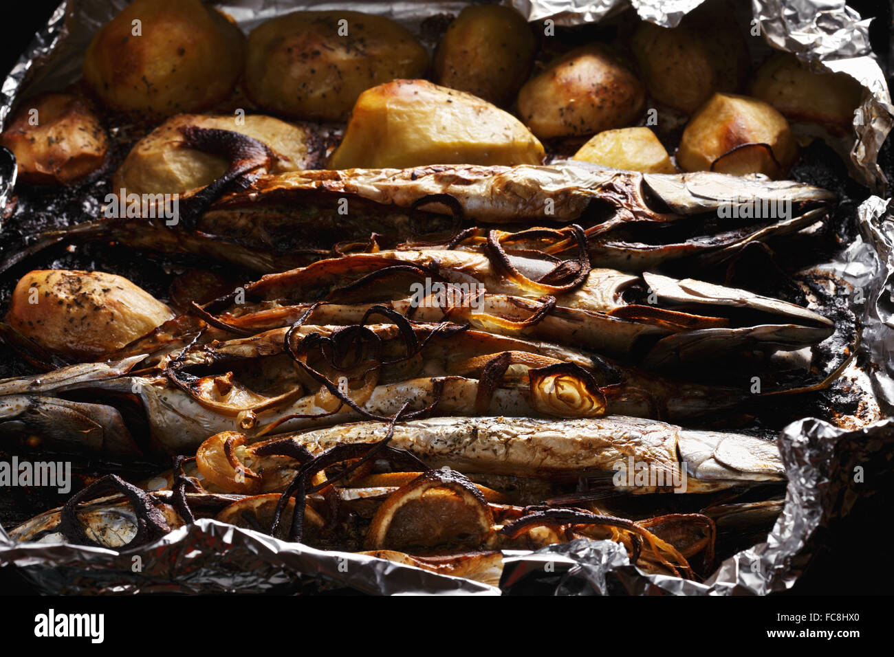 Fish baked in foil Stock Photo - Alamy